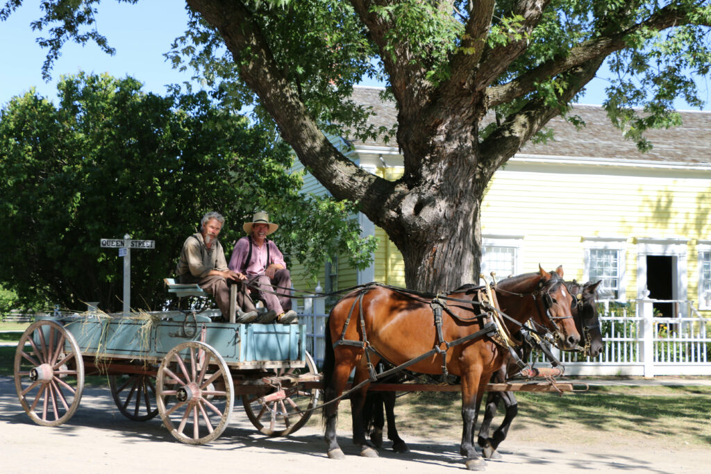 Upper Canada Village interpreters riding horse wagon